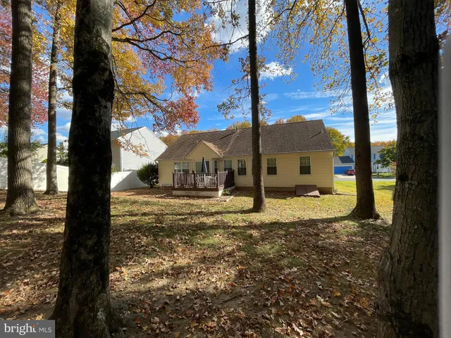 a view of a house with a yard and tree s