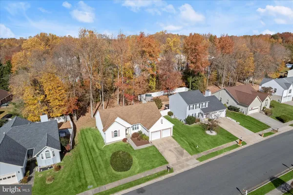 an aerial view of residential houses with outdoor space and parking