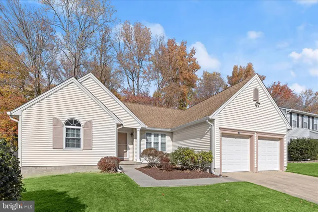 a view of a house with a yard and a garden