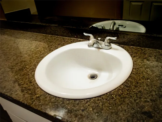 a bathroom with a sink and mirror