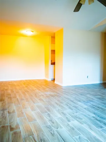 a view of an empty room and wooden floor