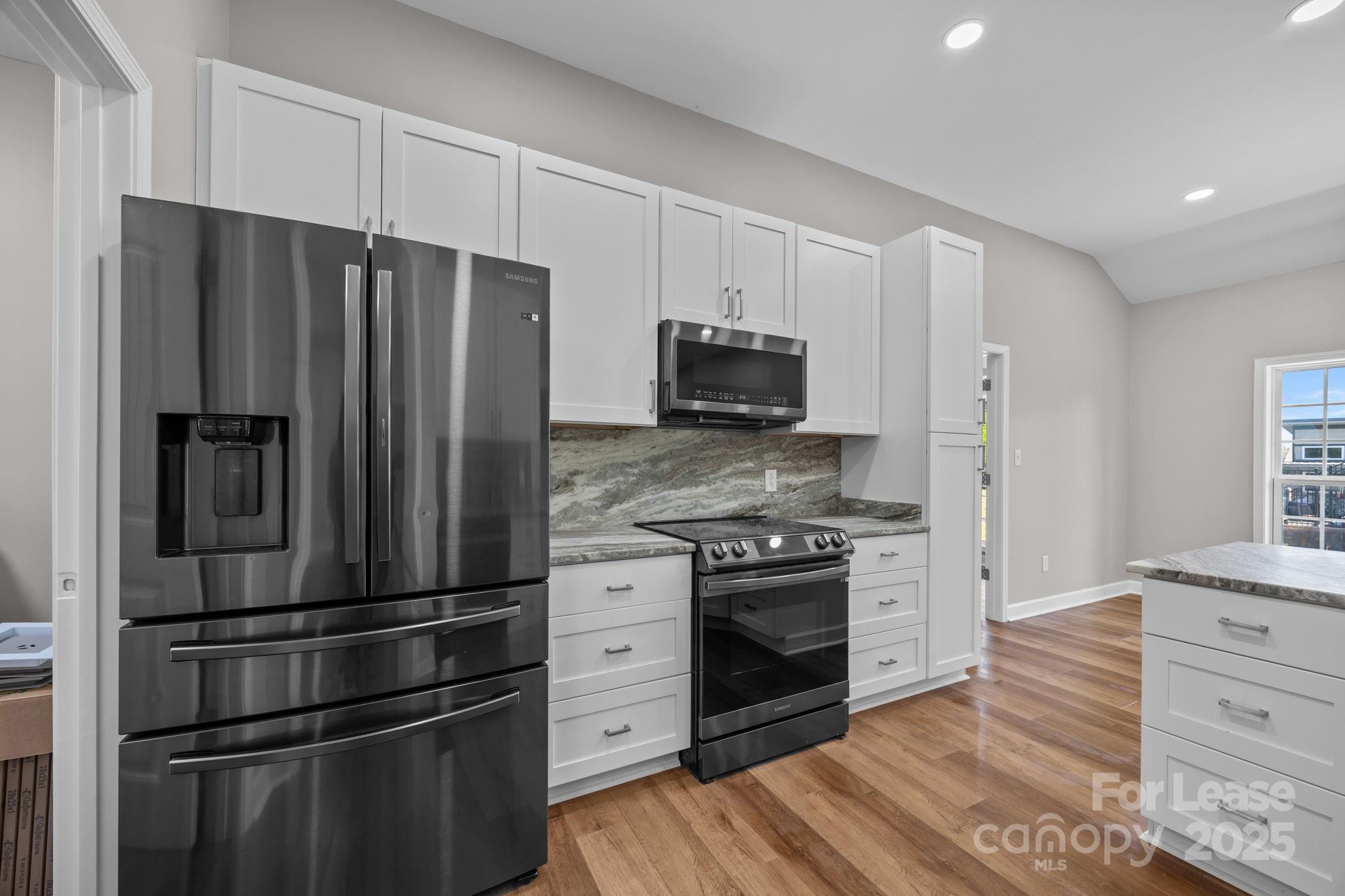 4855 New Cut Road Inman, SC 29349 - Photo 18 of 40 a kitchen with stainless steel appliances wooden cabinets and a refrigerator