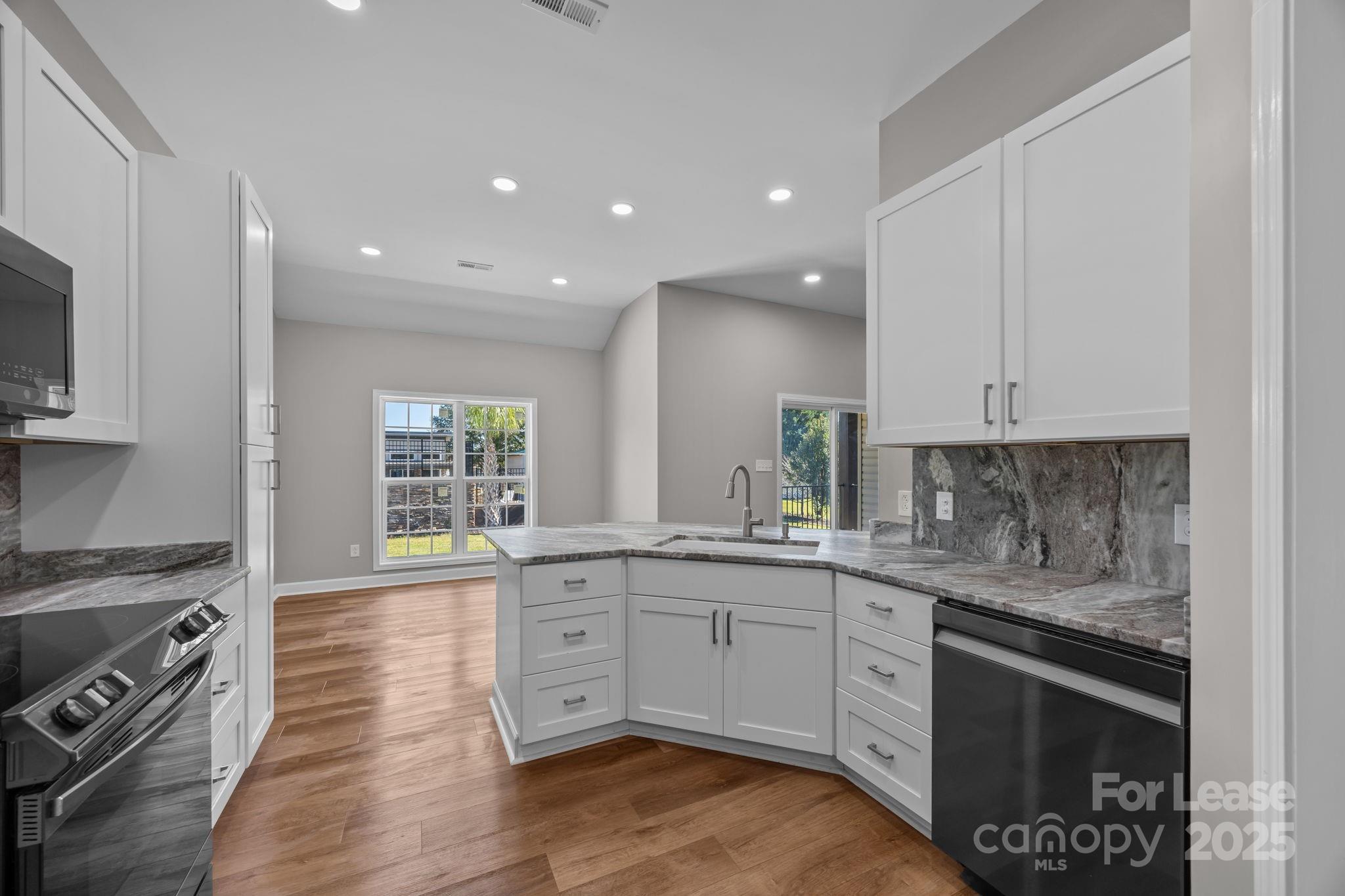 4855 New Cut Road Inman, SC 29349 - Photo 19 of 40 a kitchen with a sink stove and cabinets