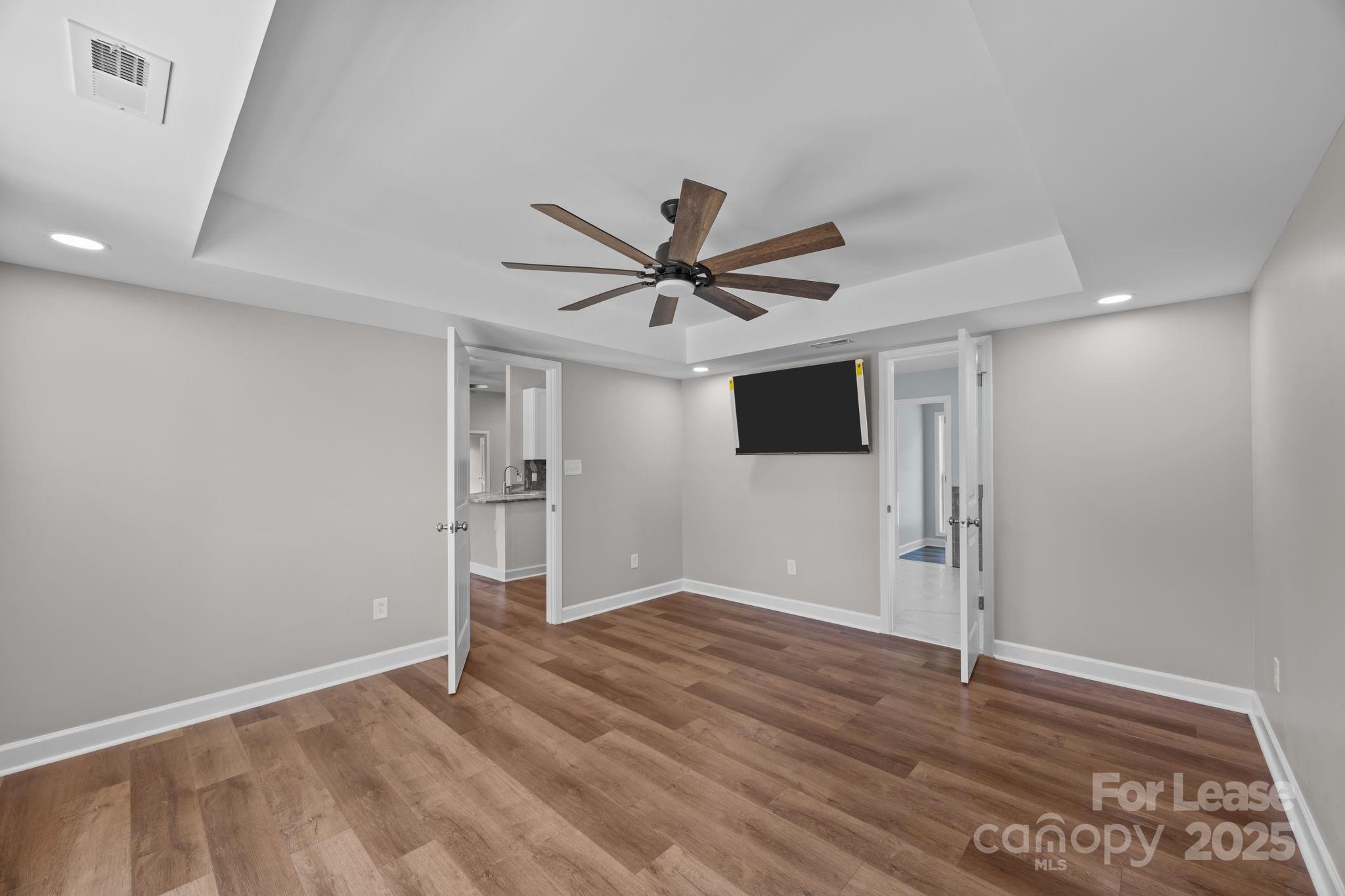 4855 New Cut Road Inman, SC 29349 - Photo 21 of 40 a view of a livingroom with a ceiling fan & wooden floor
