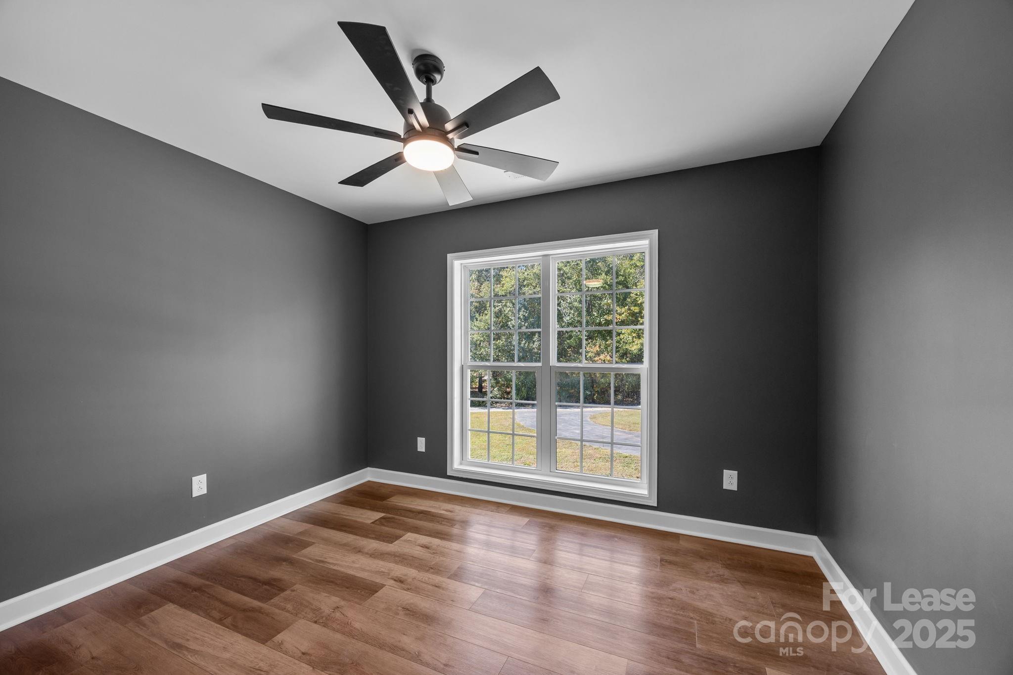 4855 New Cut Road Inman, SC 29349 - Photo 28 of 40 a view of an empty room with wooden floor and a window