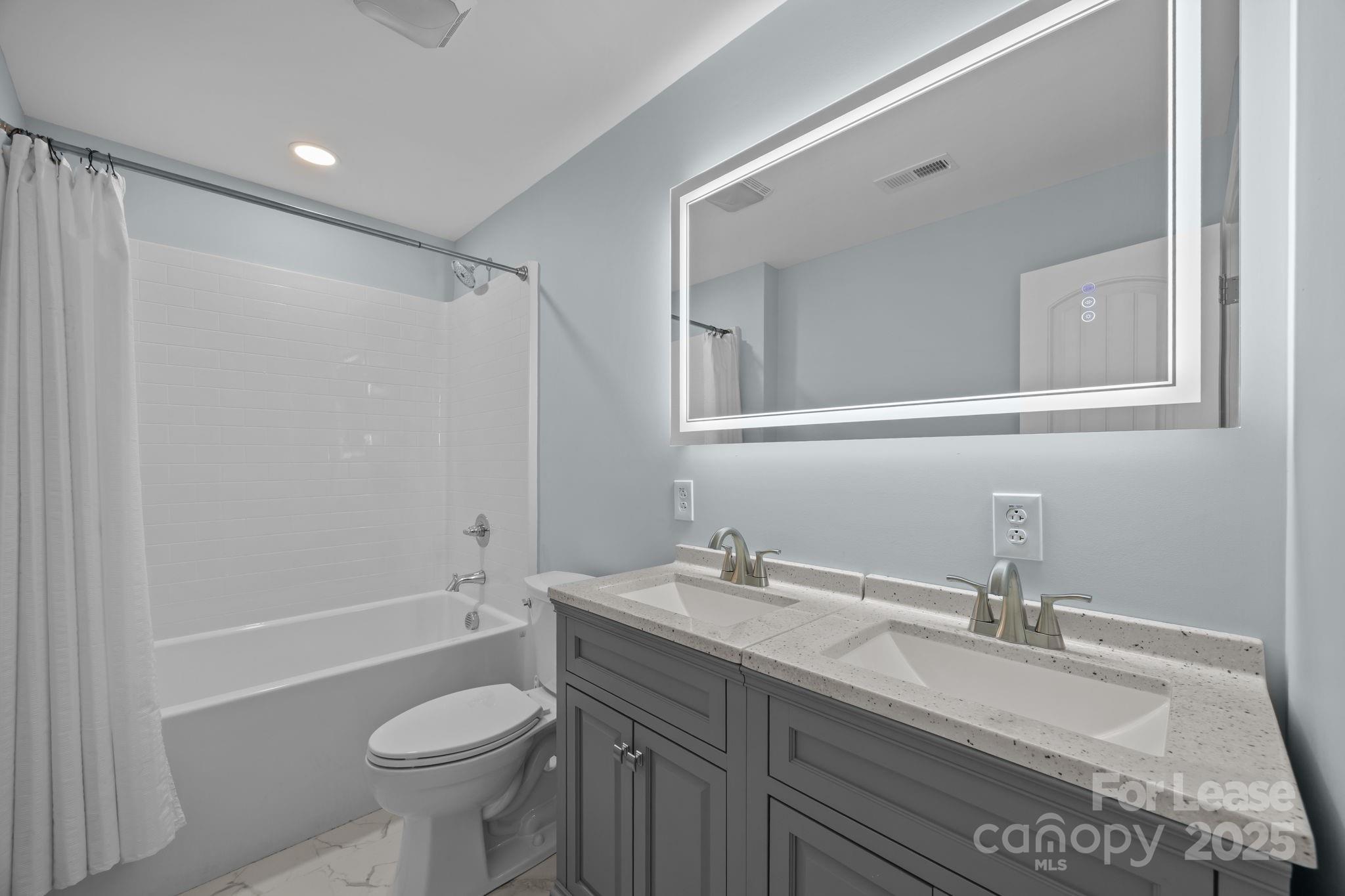 4855 New Cut Road Inman, SC 29349 - Photo 30 of 40 a bathroom with a sink toilet a mirror and shower