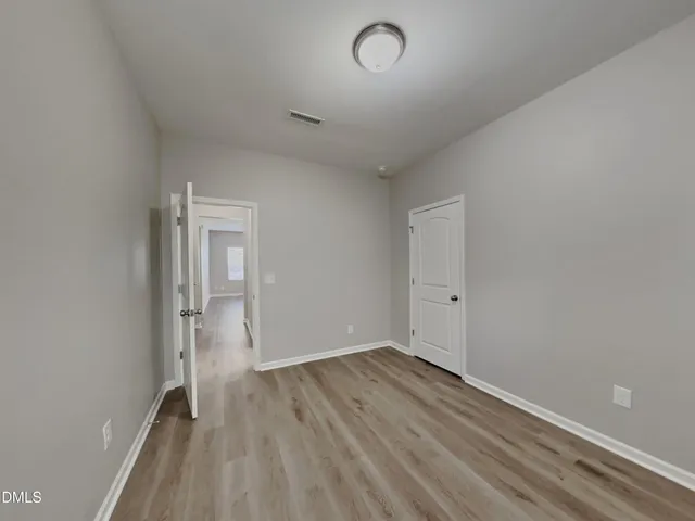 a view of wooden floor and windows in a room