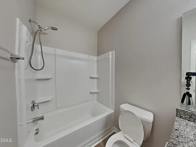 a bathroom with a toilet bathtub and shower