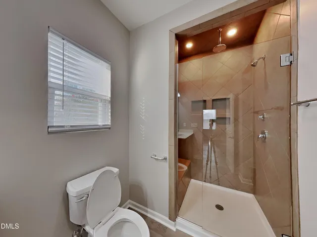 a bathroom with a shower and toilet
