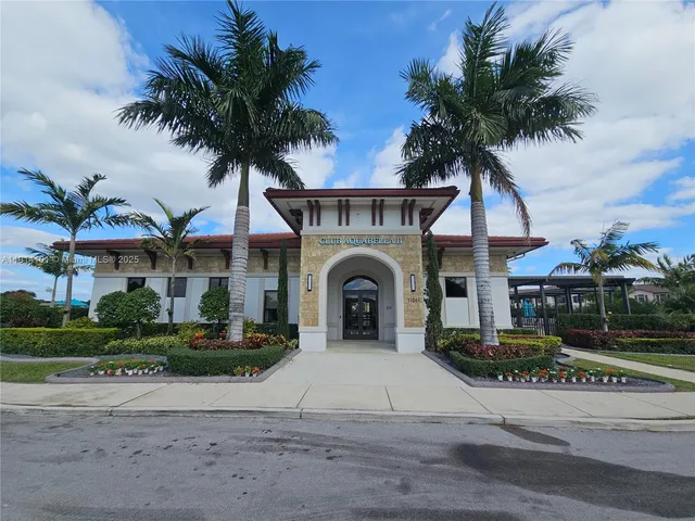 a view of a house with a swimming pool and a small yard