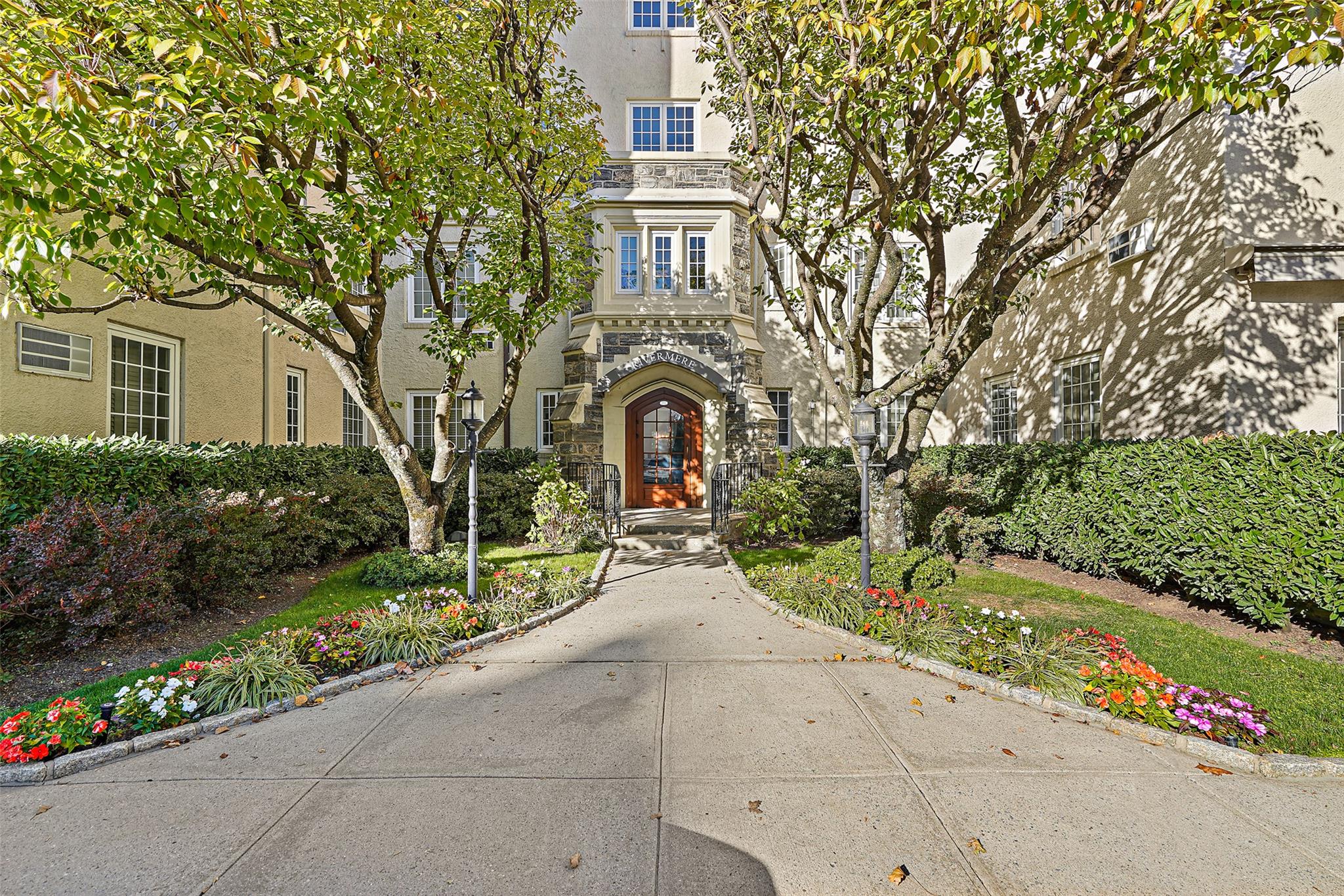 a front view of a house with a garden