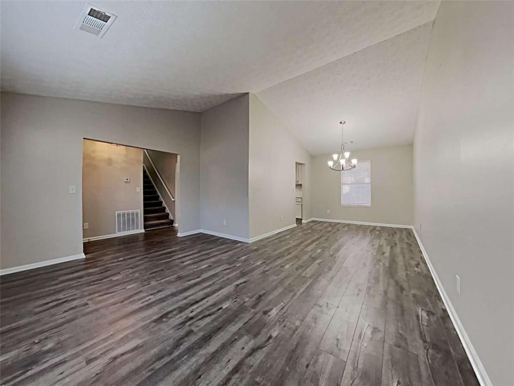 4856 Haymarket Trail Decatur, GA 30035 - Photo 12 of 23 an empty room with wooden floor and exposed radiator