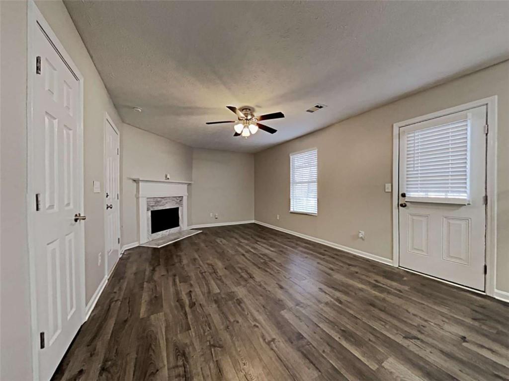4856 Haymarket Trail Decatur, GA 30035 - Photo 13 of 23 a view of a livingroom with wooden floor and a ceiling fan