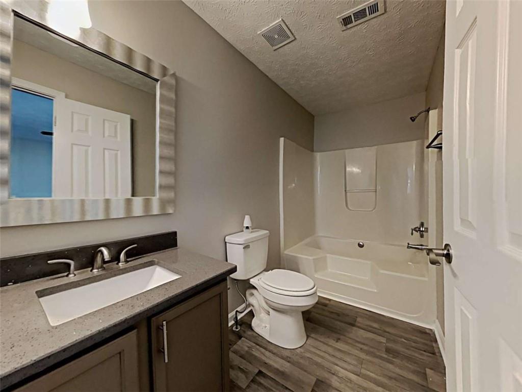 4856 Haymarket Trail Decatur, GA 30035 - Photo 21 of 23 a bathroom with a sink toilet a mirror and shower