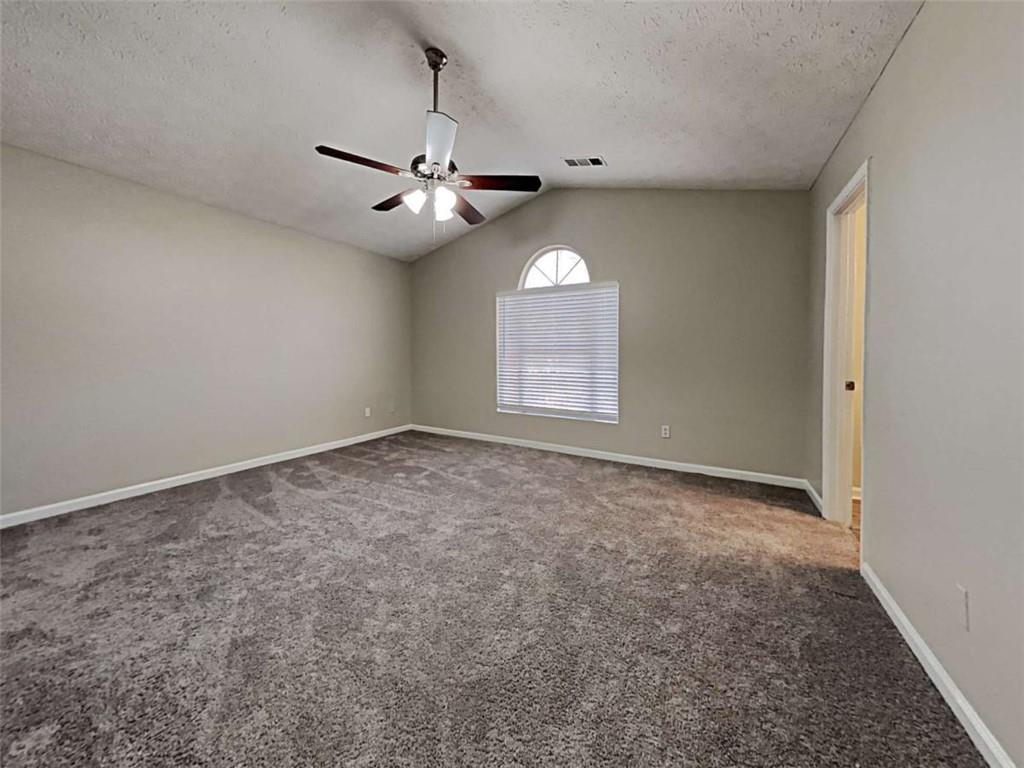 4856 Haymarket Trail Decatur, GA 30035 - Photo 4 of 23 an empty room with a window and ceiling fan