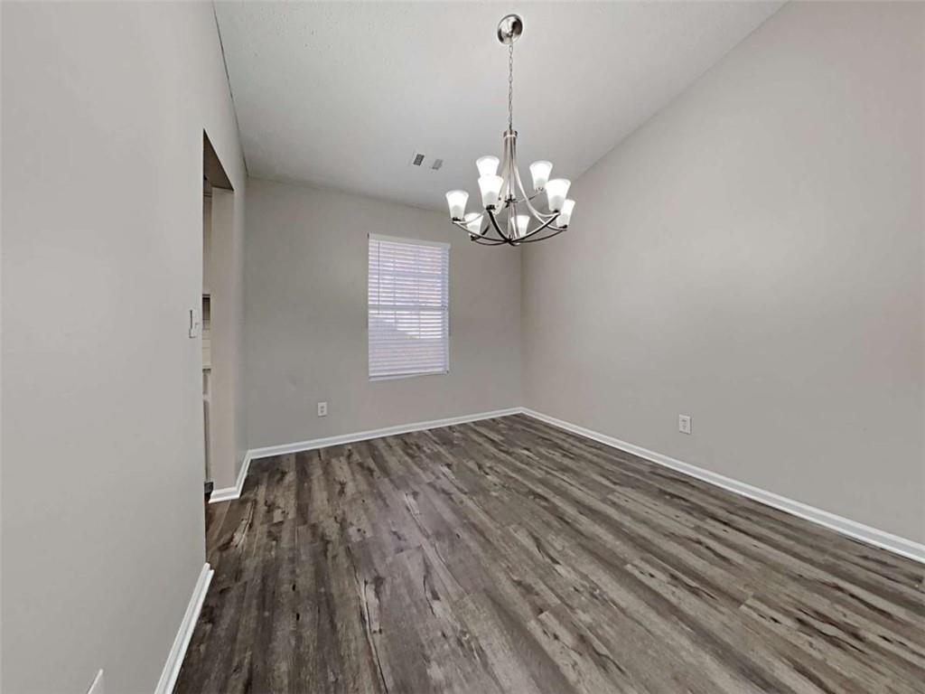 4856 Haymarket Trail Decatur, GA 30035 - Photo 5 of 23 a view of wooden floor and chandelier in a room