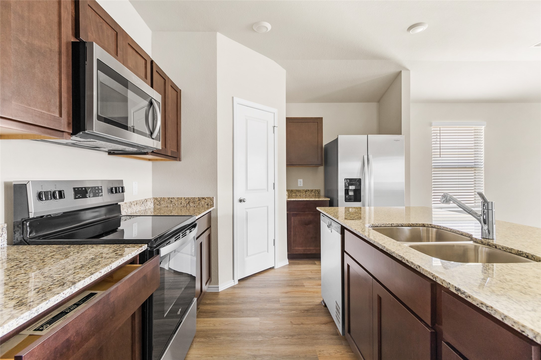 206 Rockbridge Drive Huntsville, TX 77340 - Photo 2 of 15 a kitchen with stainless steel appliances granite countertop a sink stove and refrigerator