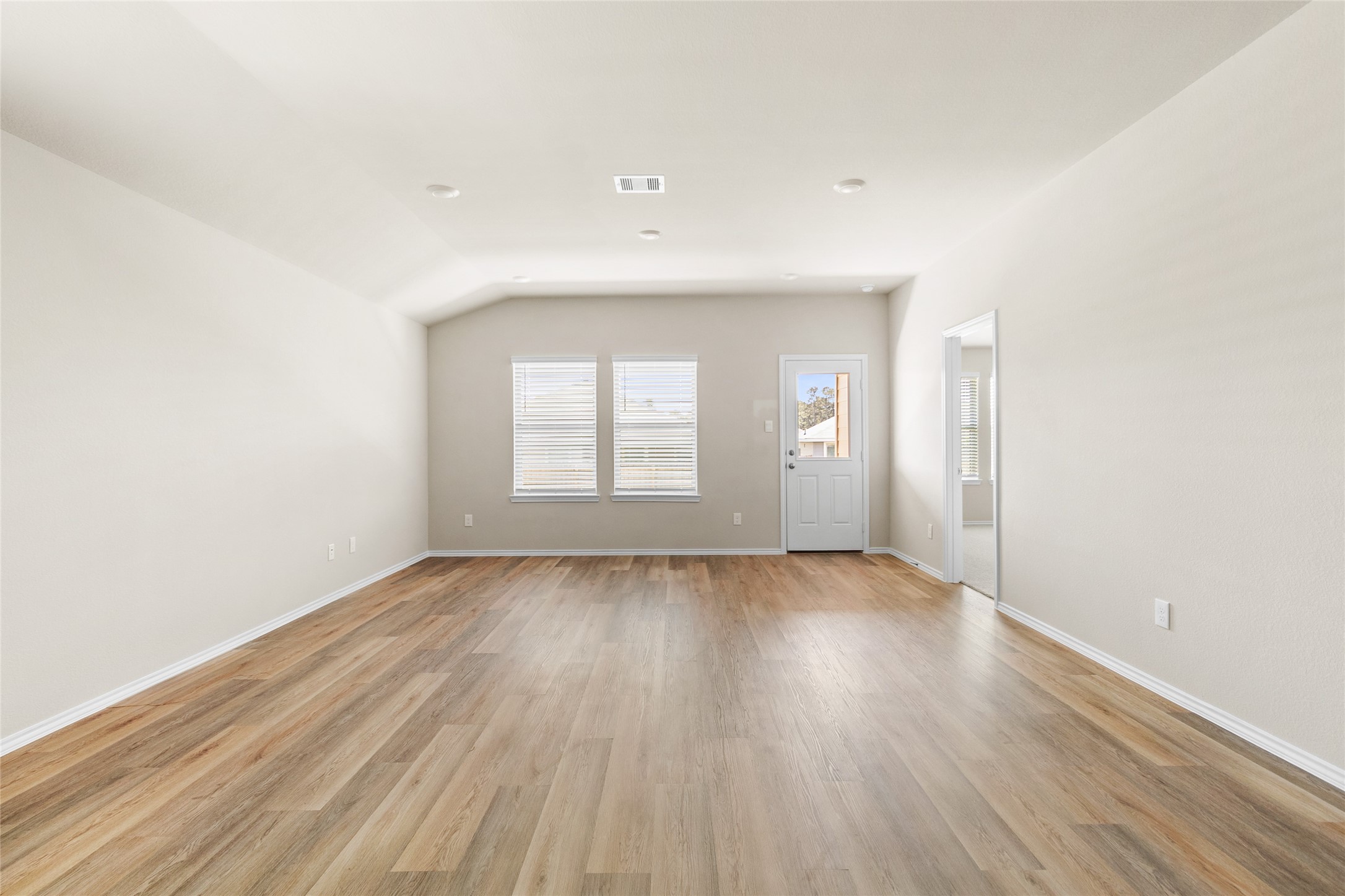 206 Rockbridge Drive Huntsville, TX 77340 - Photo 4 of 15 an empty room with wooden floor and windows
