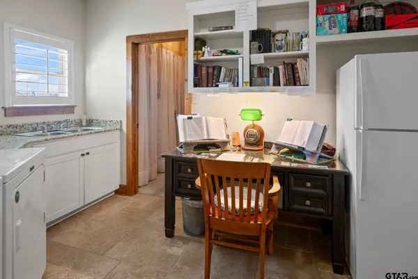 a bathroom with a granite countertop sink a toilet and a mirror