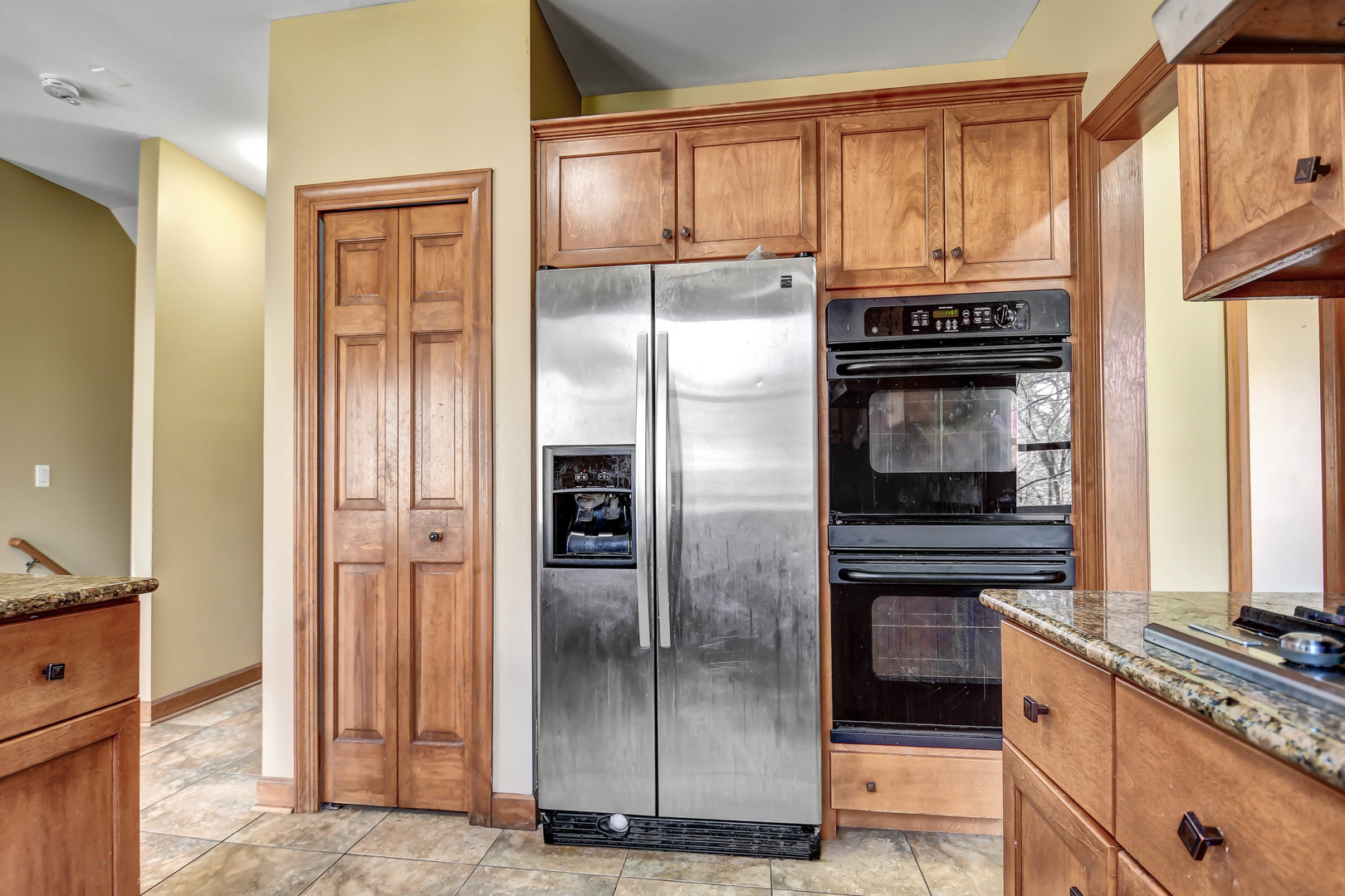 1S174 Addison Avenue Lombard, IL 60148 - Photo 11 of 37 a kitchen with stainless steel appliances granite countertop a refrigerator and a stove top oven