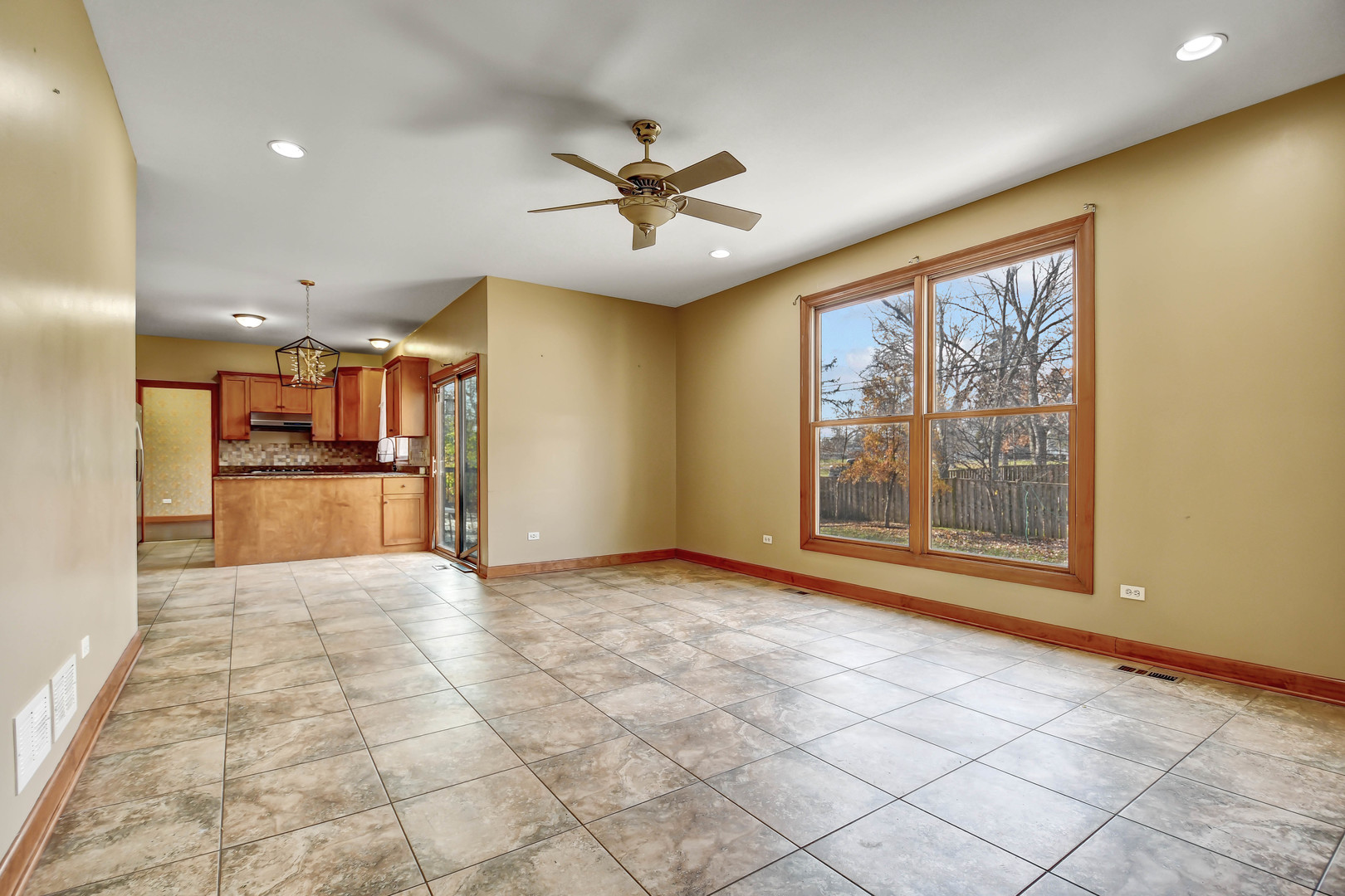 1S174 Addison Avenue Lombard, IL 60148 - Photo 15 of 37 a view of a livingroom with a chandelier fan and windows