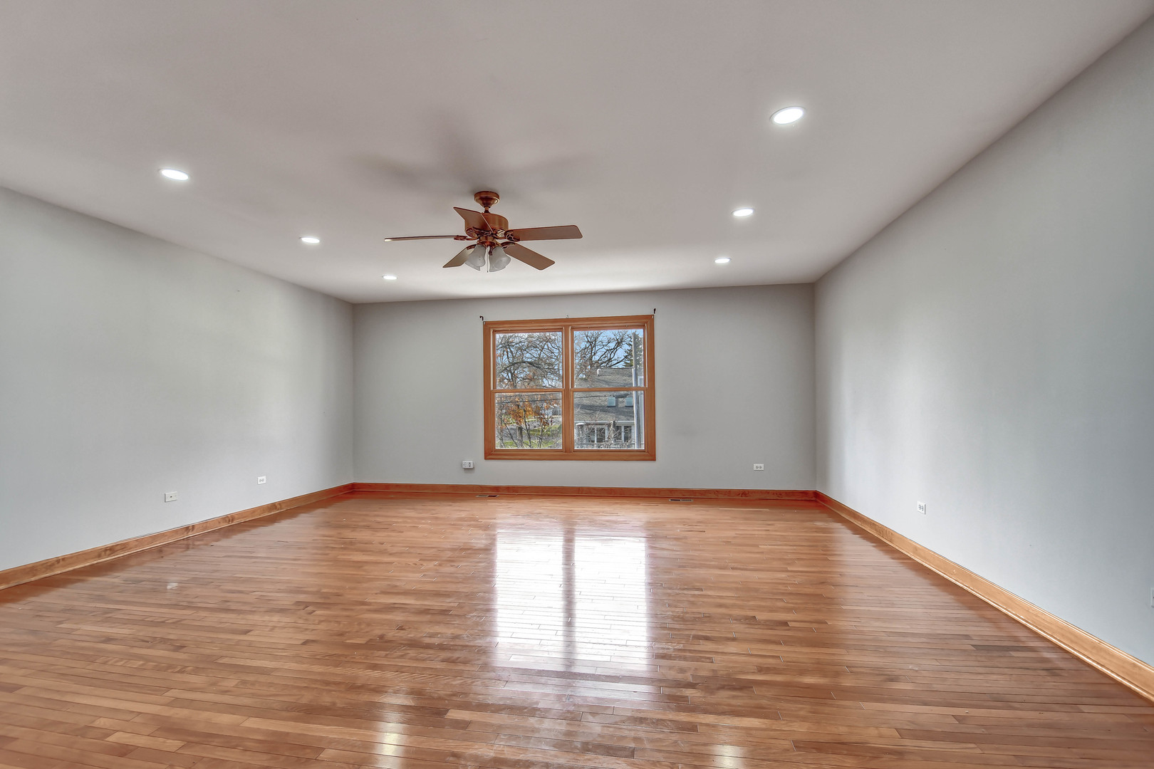 1S174 Addison Avenue Lombard, IL 60148 - Photo 18 of 37 a view of an empty room with window and wooden floor