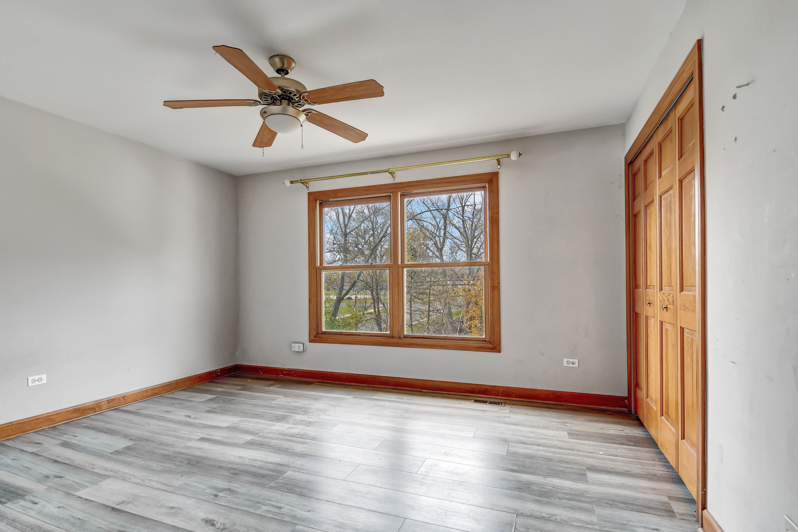 1S174 Addison Avenue Lombard, IL 60148 - Photo 23 of 37 a view of an empty room with wooden floor and a window