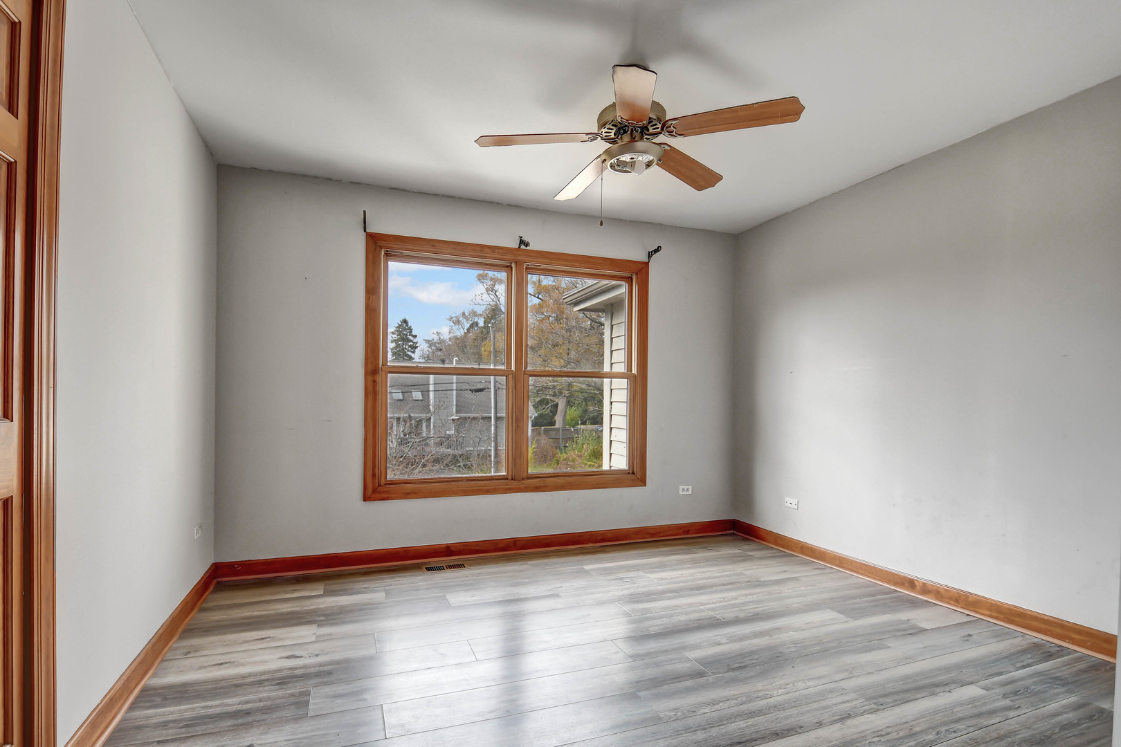 1S174 Addison Avenue Lombard, IL 60148 - Photo 24 of 37 a view of an empty room with a window and wooden floor