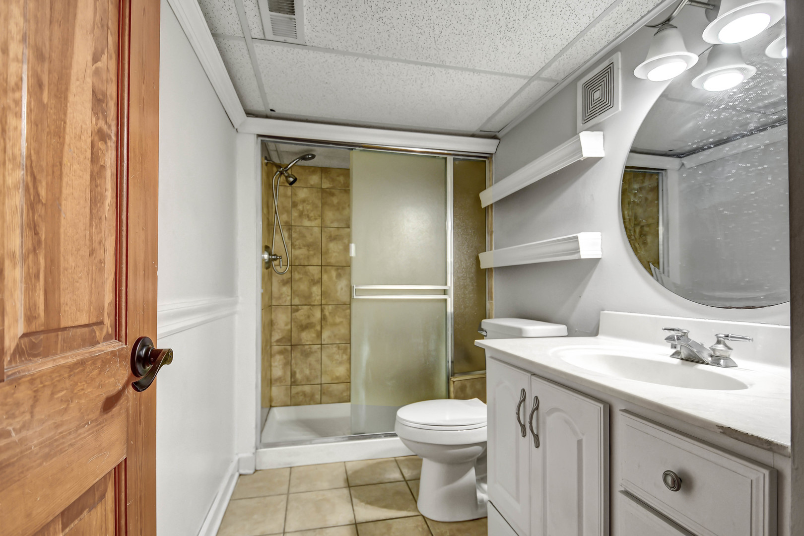 1S174 Addison Avenue Lombard, IL 60148 - Photo 30 of 37 a bathroom with a sink toilet and shower