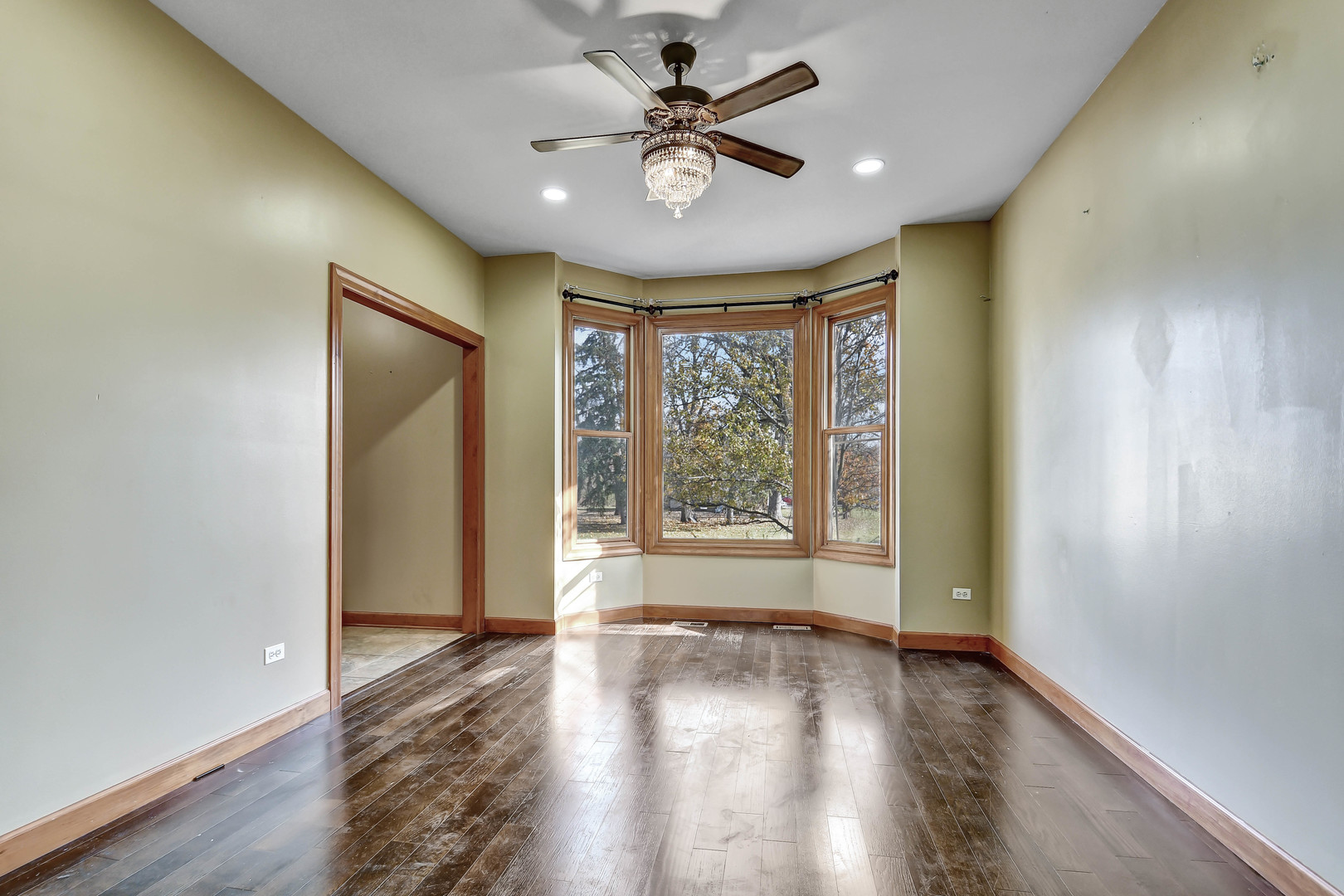 1S174 Addison Avenue Lombard, IL 60148 - Photo 3 of 37 an empty room with wooden floor and windows
