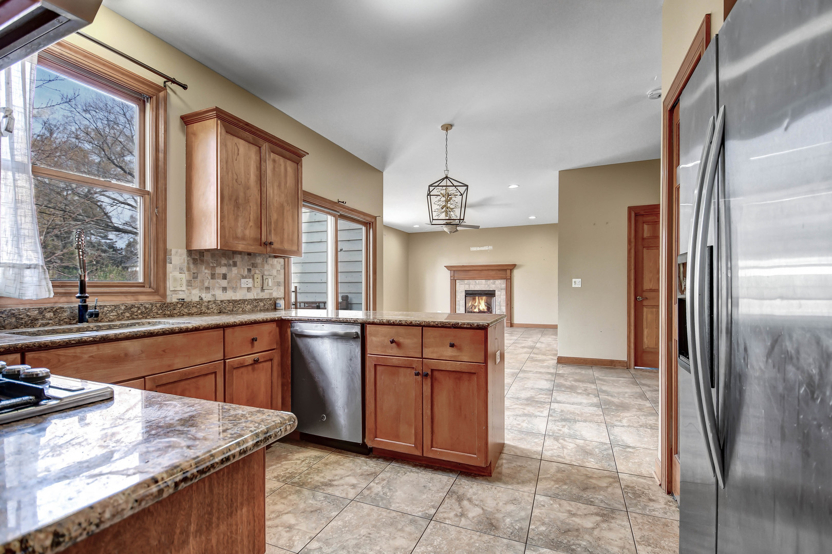 1S174 Addison Avenue Lombard, IL 60148 - Photo 7 of 37 a large kitchen with stainless steel appliances granite countertop a refrigerator and a sink