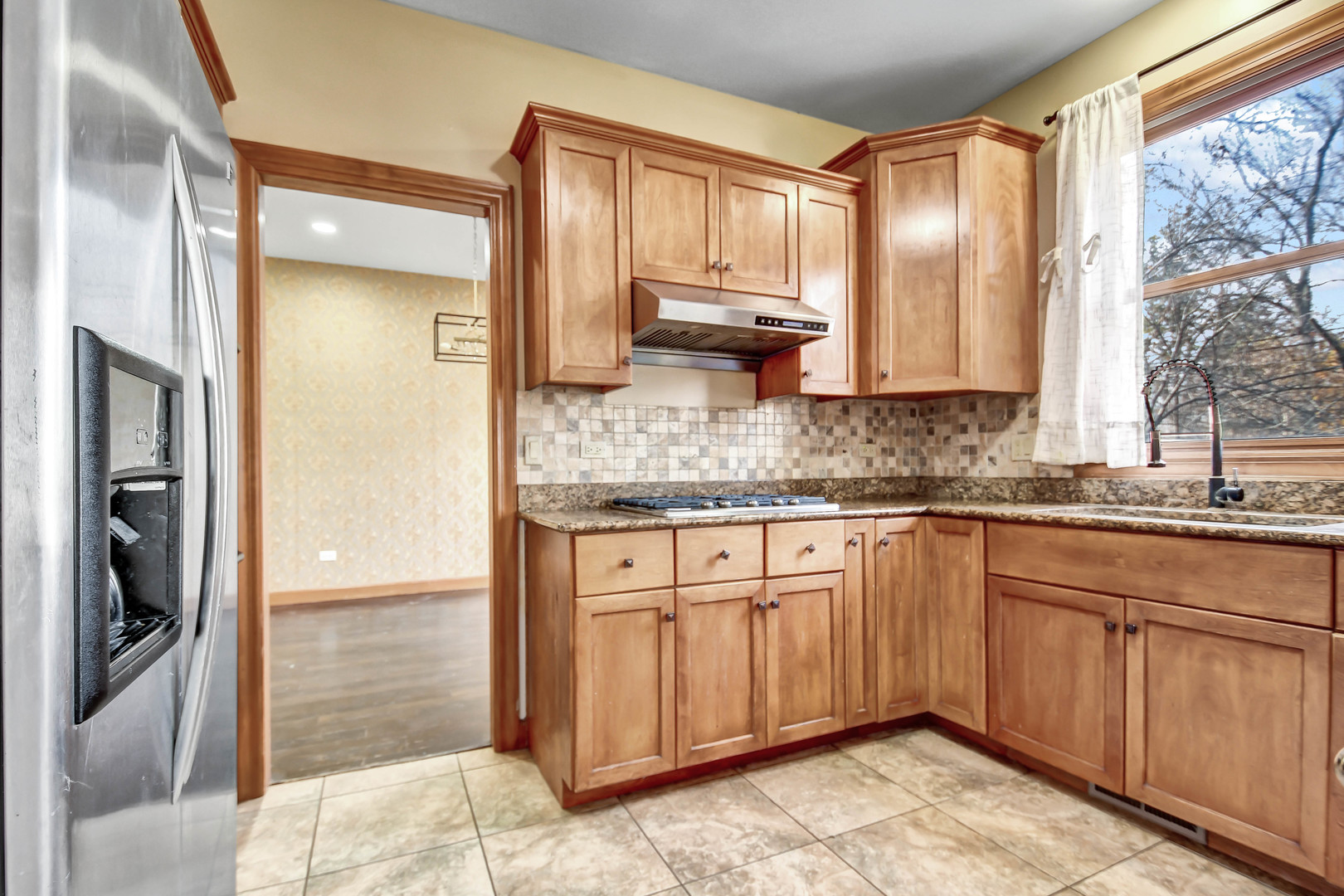 1S174 Addison Avenue Lombard, IL 60148 - Photo 10 of 37 a kitchen with stainless steel appliances granite countertop a refrigerator and a sink