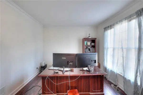 a view of a workspace with furniture and window