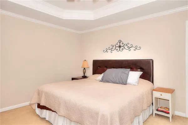 a bedroom with a bed and a night stand