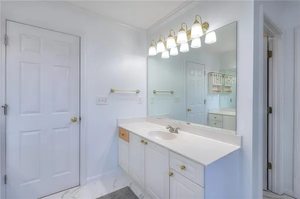 a bathroom with a sink a mirror and a shower