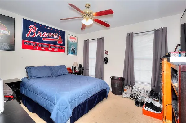 a bedroom with a bed and a chandelier