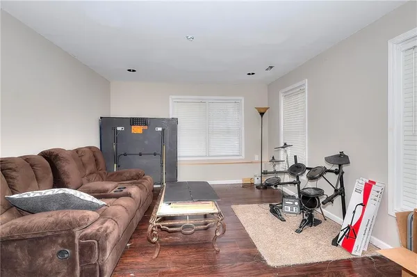 a living room with furniture and a wooden floor