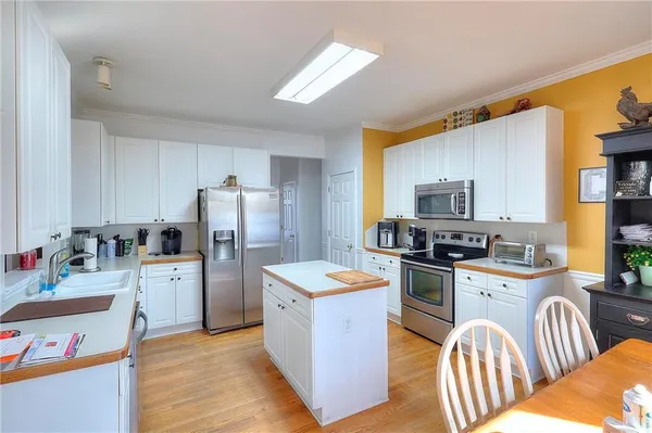 a kitchen with a refrigerator stove top oven and sink