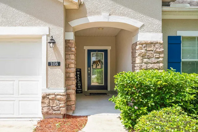 a view of a house with a yard and sitting area