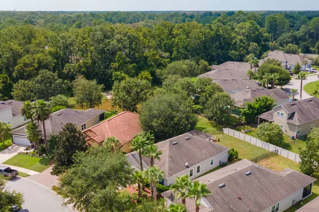 an aerial view of a houses with a yard