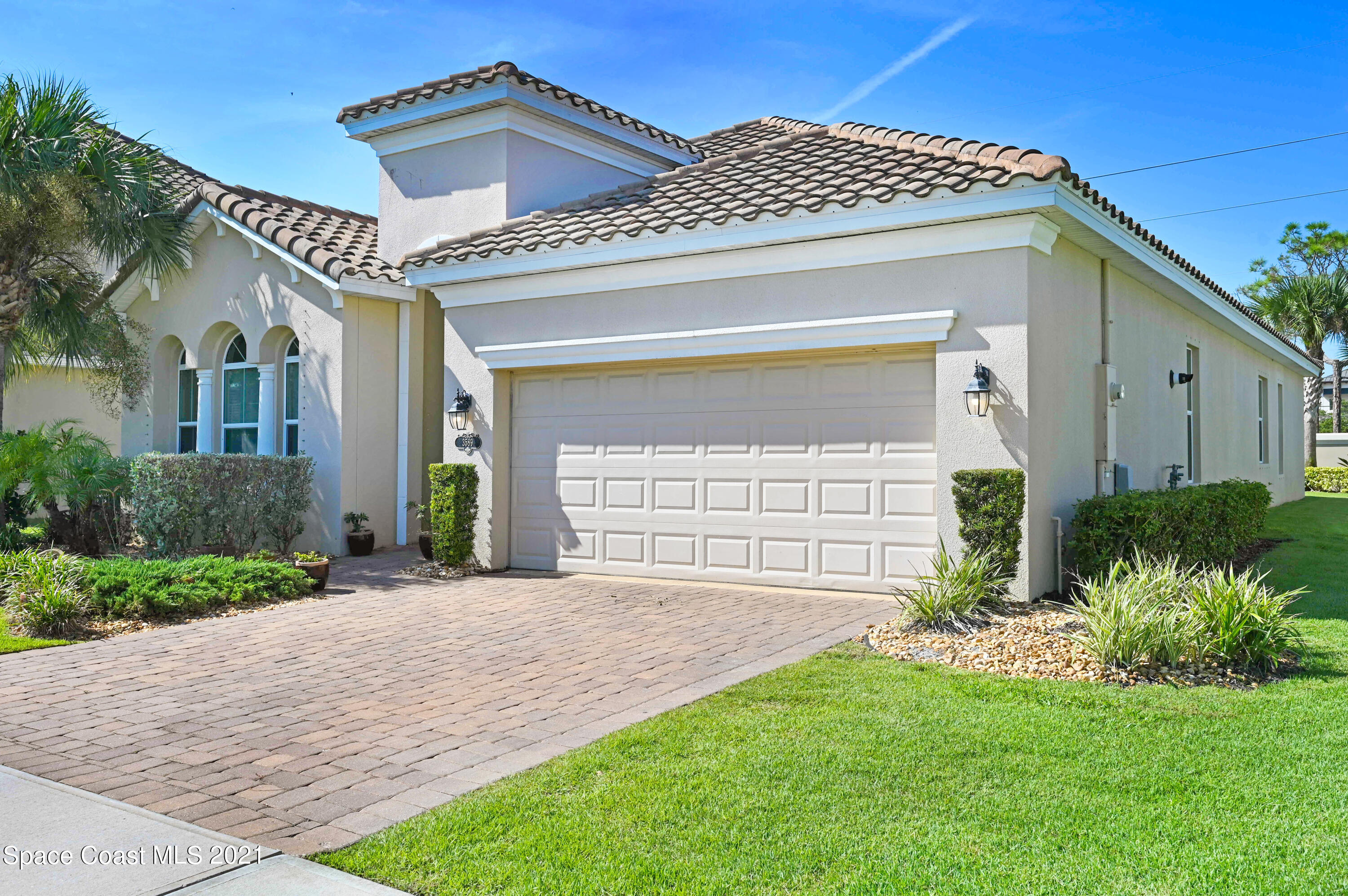 3589 Poseidon Way Indialantic, FL 32903 - Photo 1 of 3 a front view of a house with a garden and plants