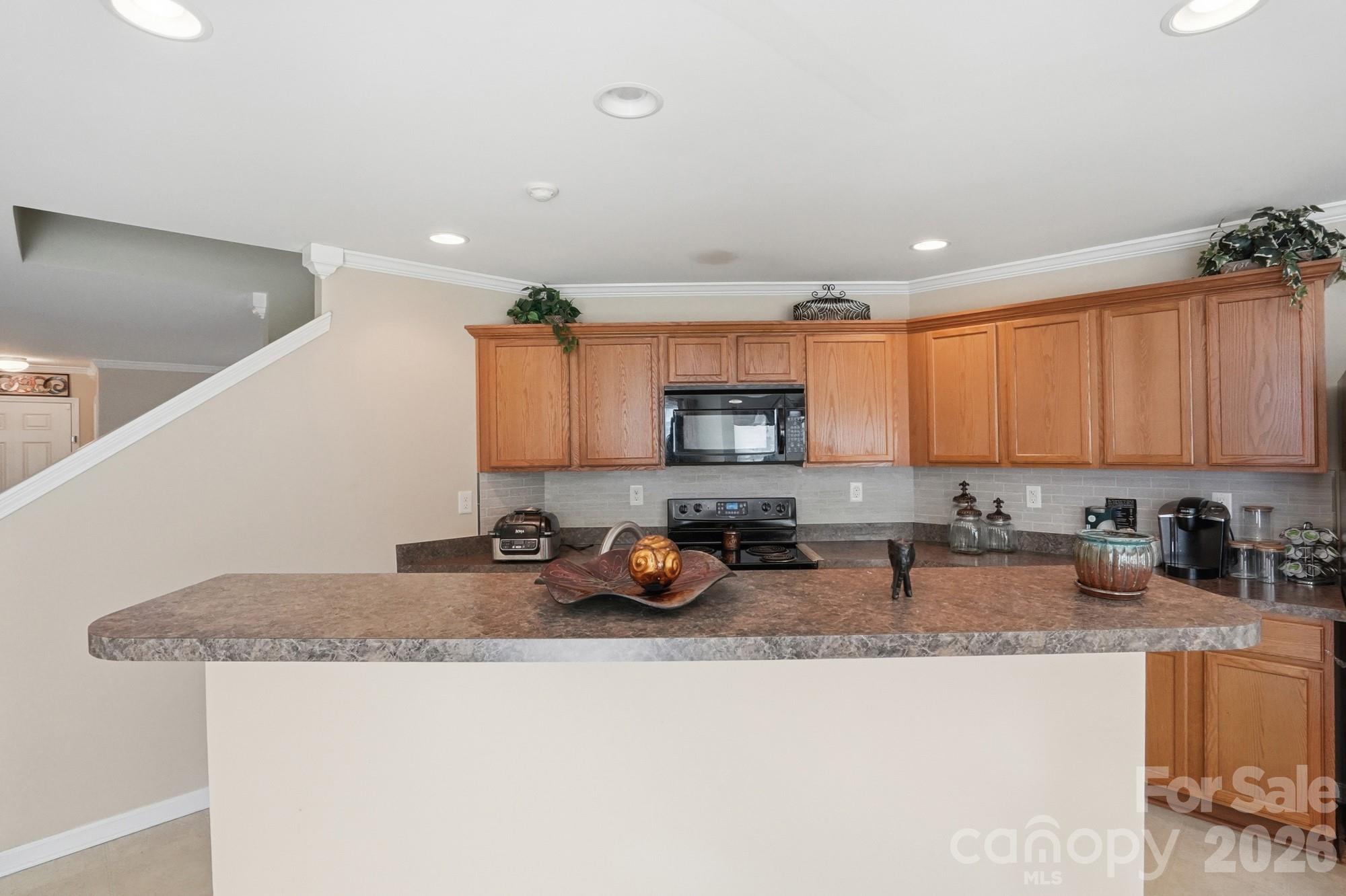 4404 Kiddle Lane Monroe, NC 28110 - Photo 14 of 48 a kitchen with stainless steel appliances granite countertop a sink a stove a refrigerator a counter top space and cabinets