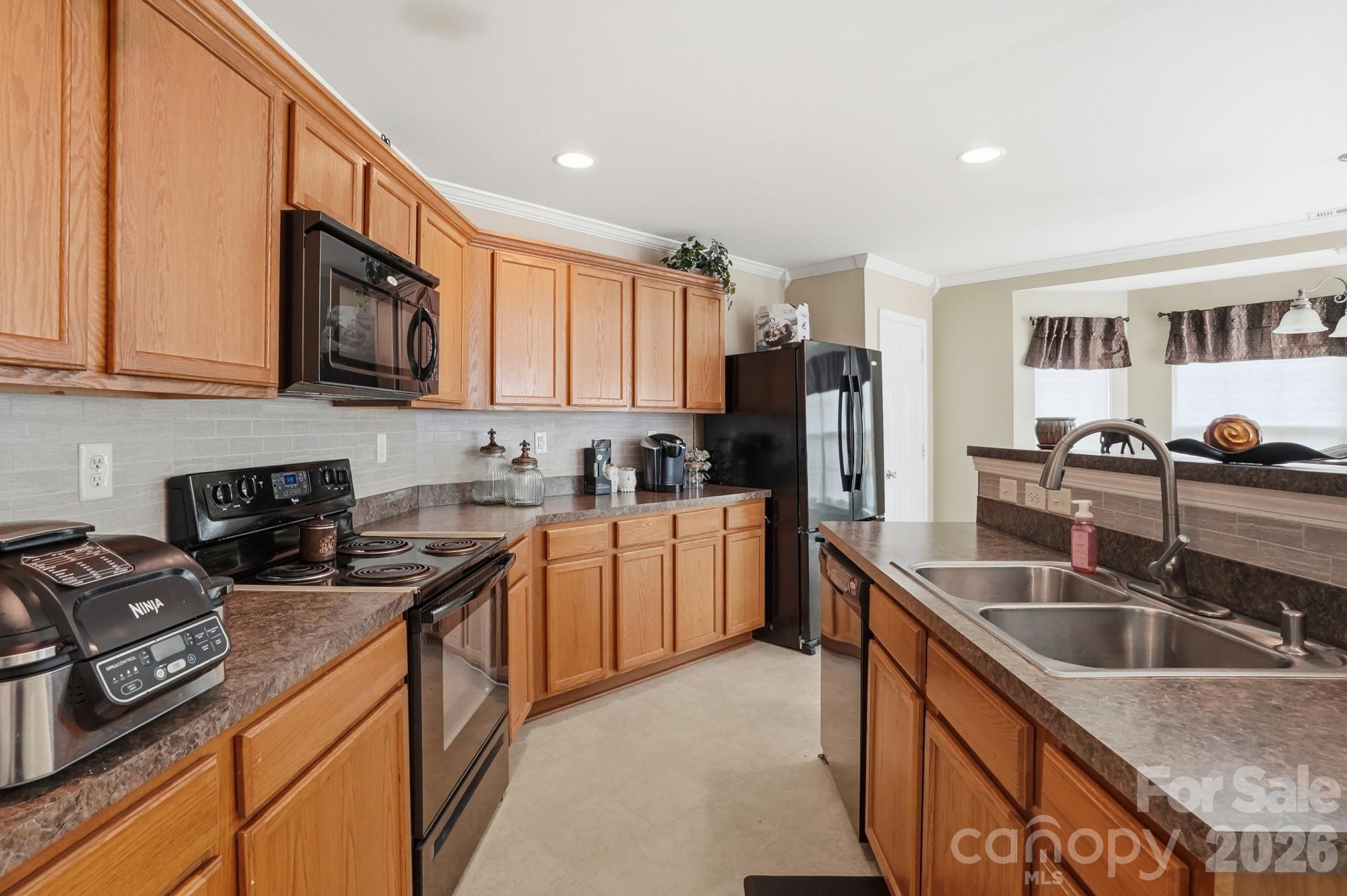 4404 Kiddle Lane Monroe, NC 28110 - Photo 15 of 48 a kitchen with stainless steel appliances granite countertop a sink stove and refrigerator