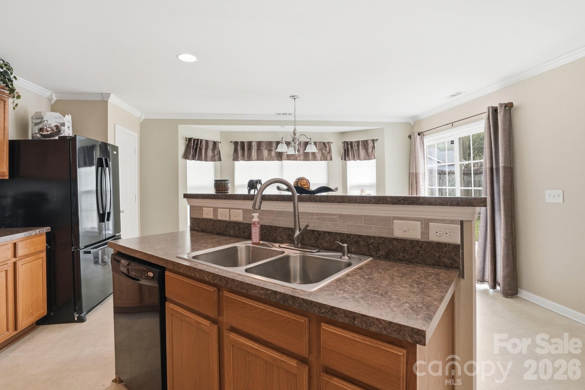 4404 Kiddle Lane Monroe, NC 28110 - Photo 16 of 48 a kitchen with stainless steel appliances granite countertop a sink and a refrigerator