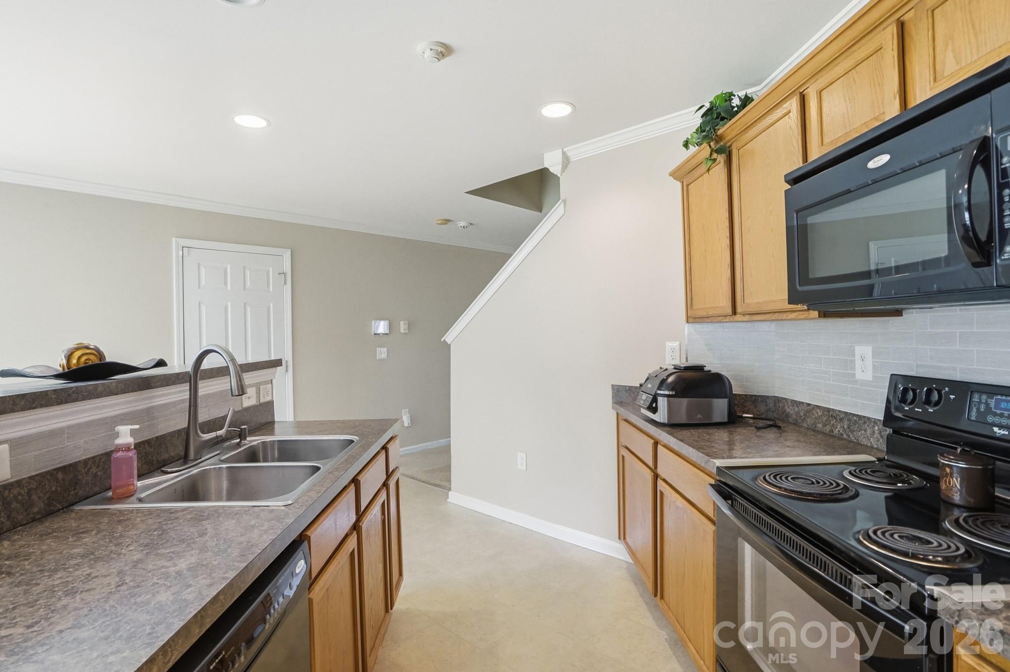 4404 Kiddle Lane Monroe, NC 28110 - Photo 17 of 48 a kitchen that has a sink and a stove