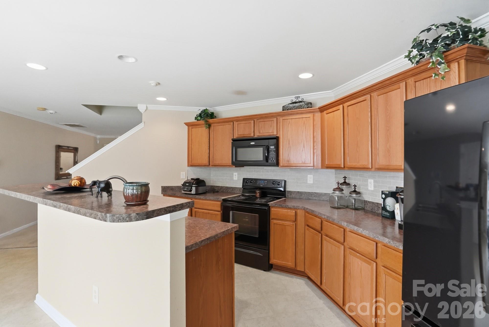 4404 Kiddle Lane Monroe, NC 28110 - Photo 18 of 48 a kitchen with stainless steel appliances granite countertop a sink stove and refrigerator