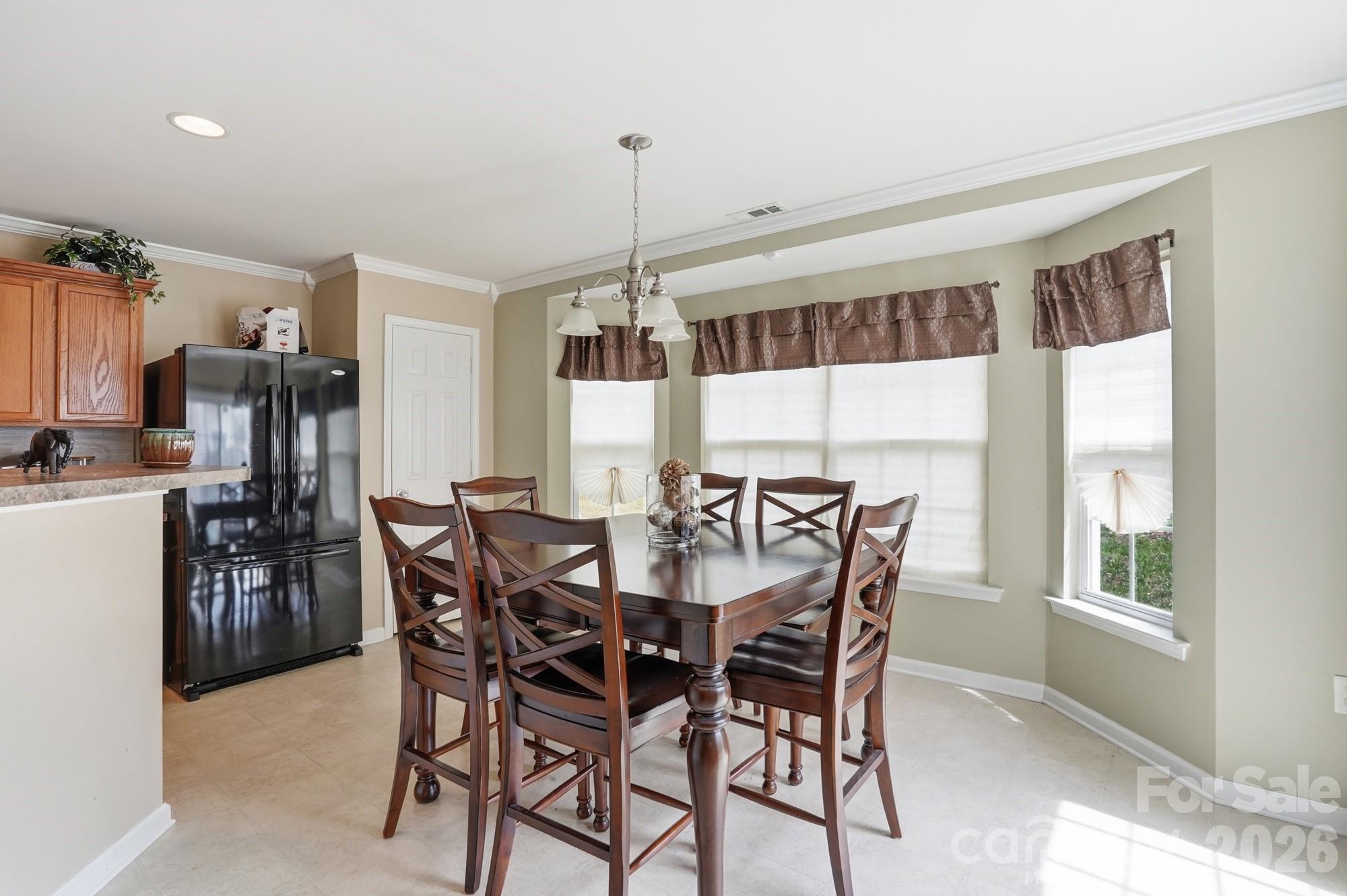 4404 Kiddle Lane Monroe, NC 28110 - Photo 20 of 48 a view of a dining room and livingroom with furniture window and wooden floor