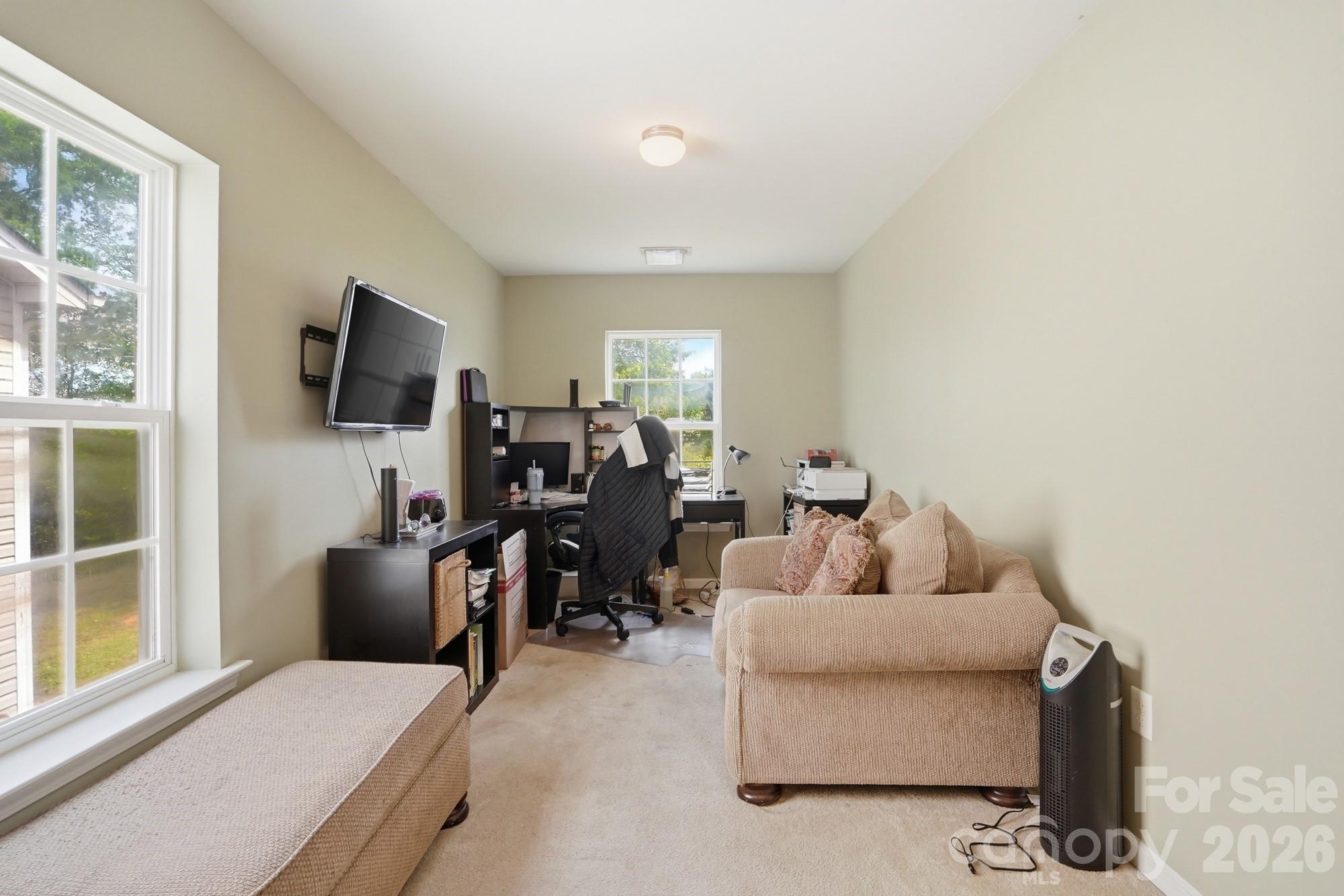 4404 Kiddle Lane Monroe, NC 28110 - Photo 24 of 48 a living room with furniture a flat screen tv and large window