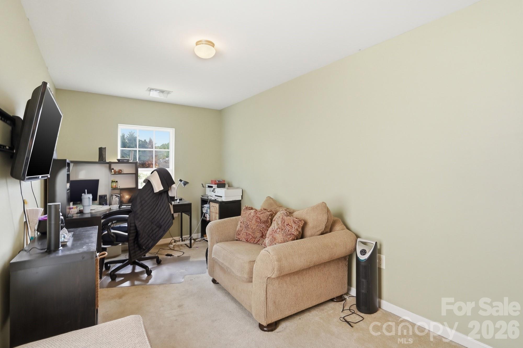 4404 Kiddle Lane Monroe, NC 28110 - Photo 25 of 48 a living room with furniture a flat screen tv and a window
