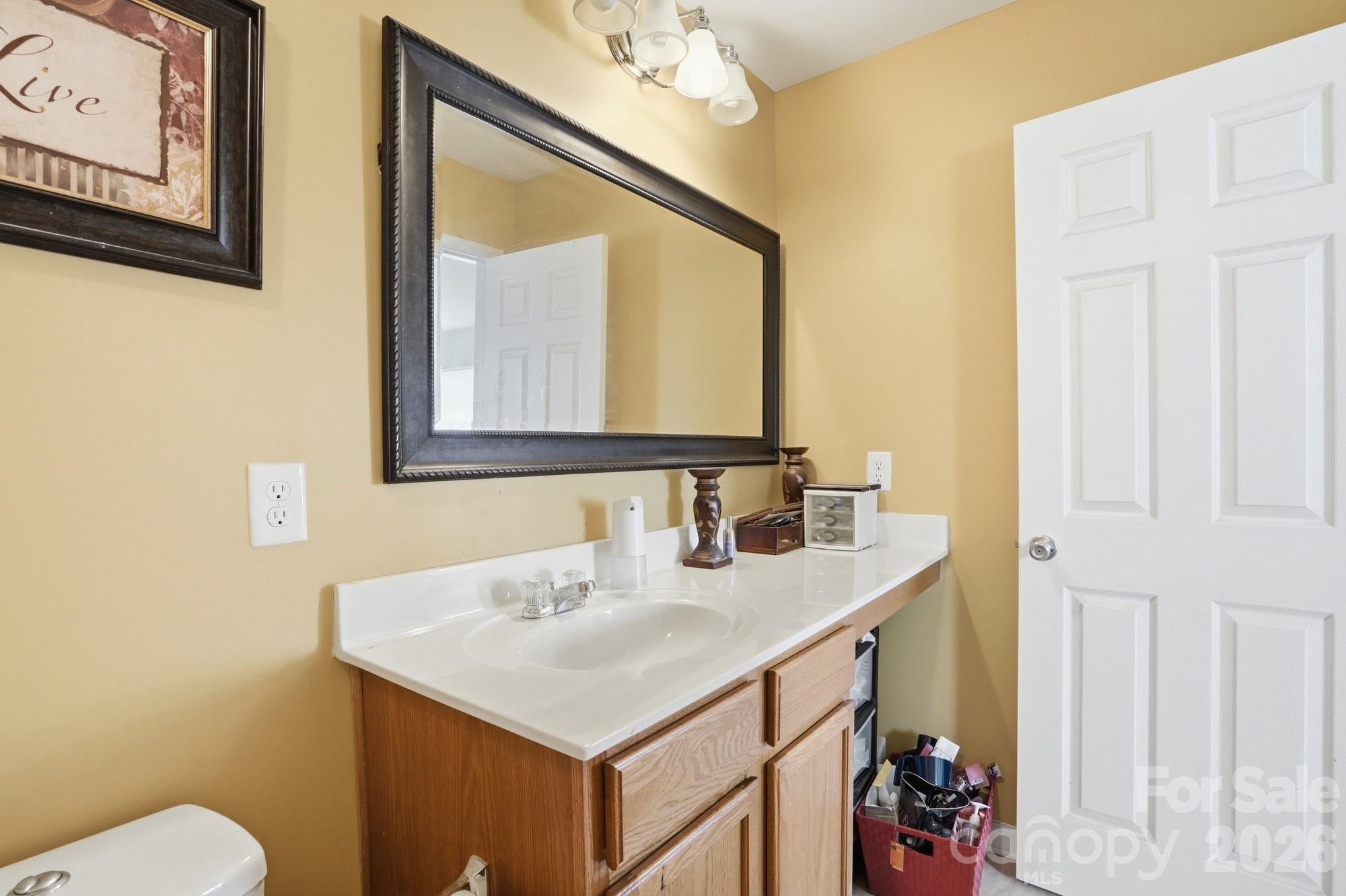 4404 Kiddle Lane Monroe, NC 28110 - Photo 31 of 48 a bathroom with a sink vanity and a mirror